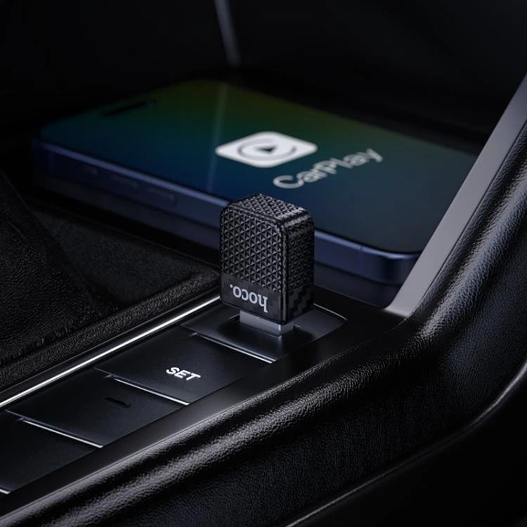 Car air freshener with 'ioco' branding on a car dashboard next to a smartphone displaying CarPlay - Lebtech Store