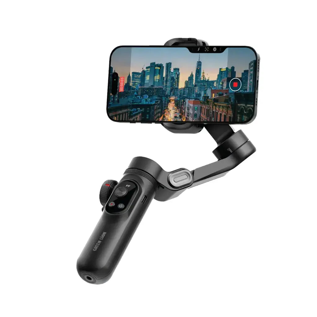 Handheld smartphone stabilizer with phone attached, displaying a cityscape on screen.