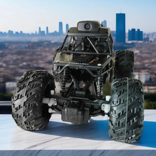 Toy monster truck with large wheels on a surface with a cityscape in the background