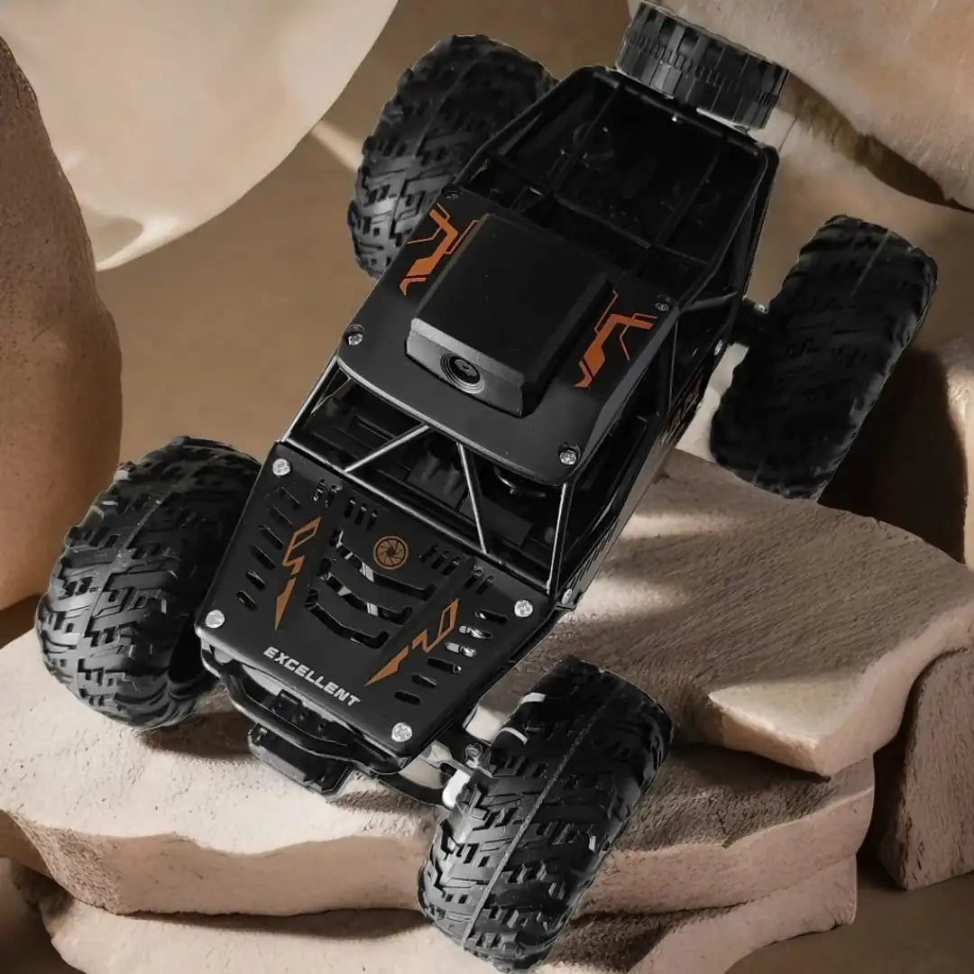 Toy monster truck with large wheels on a surface up view