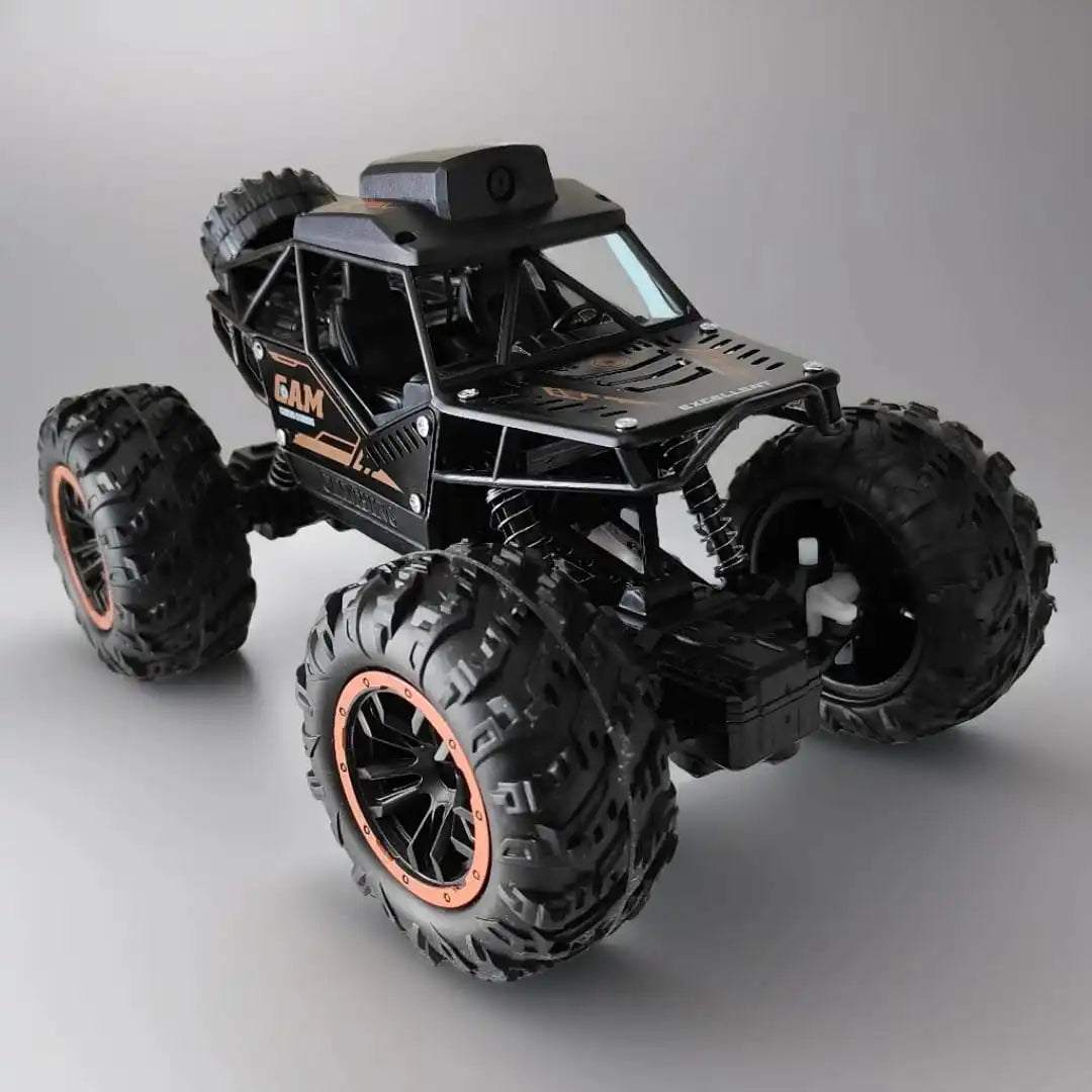 Toy monster truck with large wheels on a surface side vew
