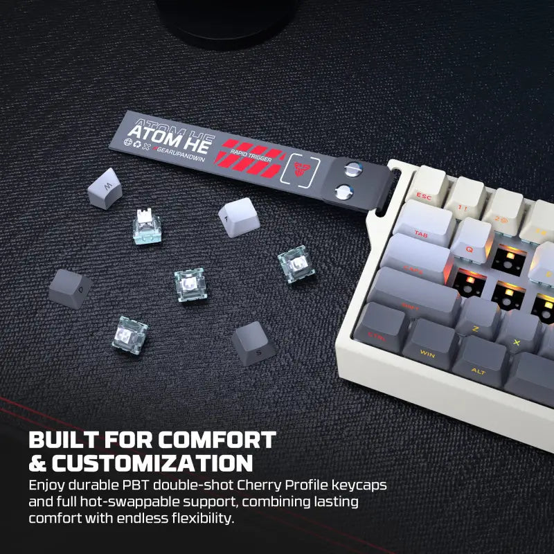 Mechanical keyboard with keycaps and a keycap puller on a dark surface, emphasizing comfort and customization.
