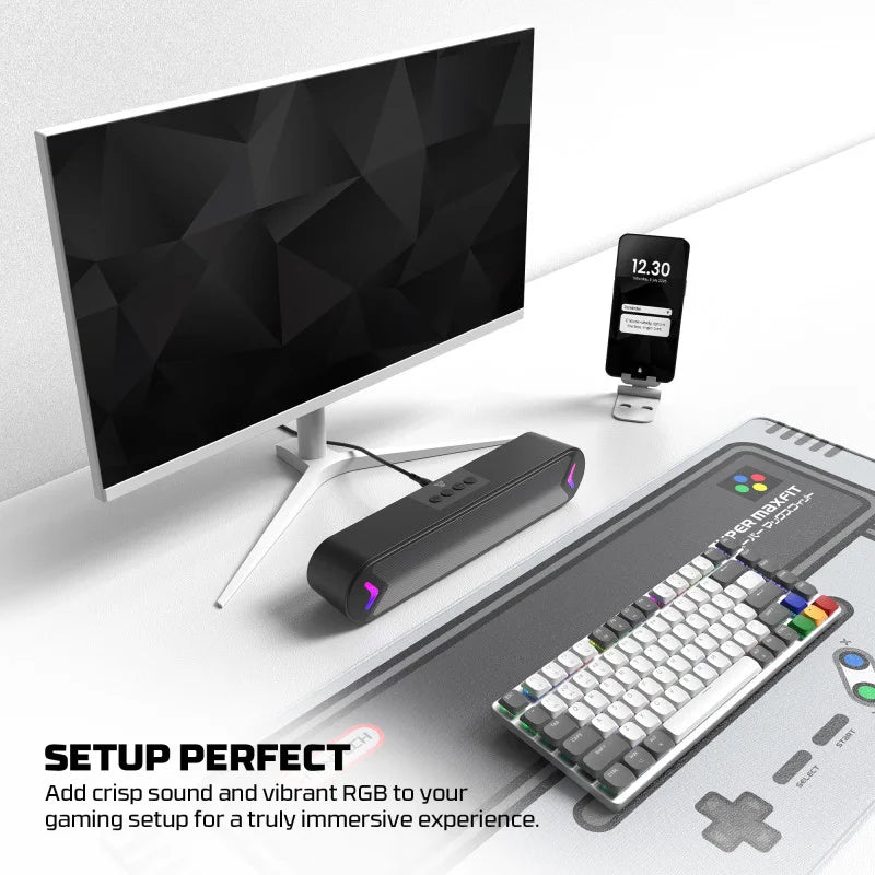 Gaming setup with monitor, keyboard, and phone on a white surface LebTech Store