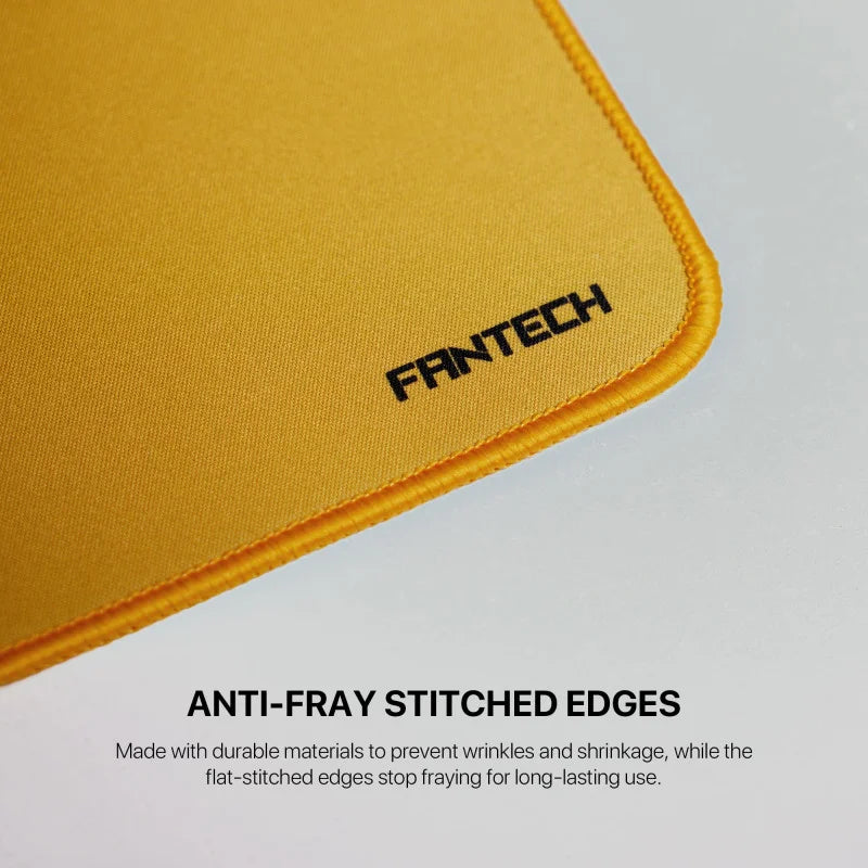 A close-up of an orange Fantech MP70 Large Desk Mat from LebTech Store Lebanon, highlighting its anti-fray stitched edges. The text explains that these flat-stitched edges prevent fraying, wrinkles, and shrinkage for long-lasting durability.
