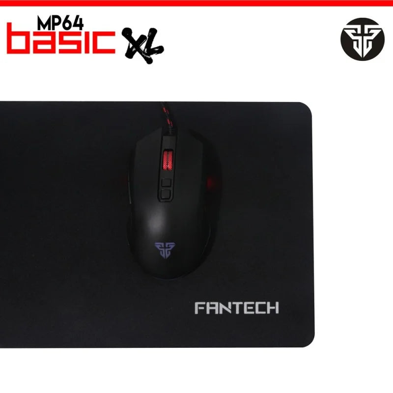 A top-down view of a gaming mouse on the Fantech MP64 Basic XL Mousepad from LebTech Store Lebanon. The black mat features a minimalist design with the Fantech logo, offering a large, smooth surface for high-precision tracking.