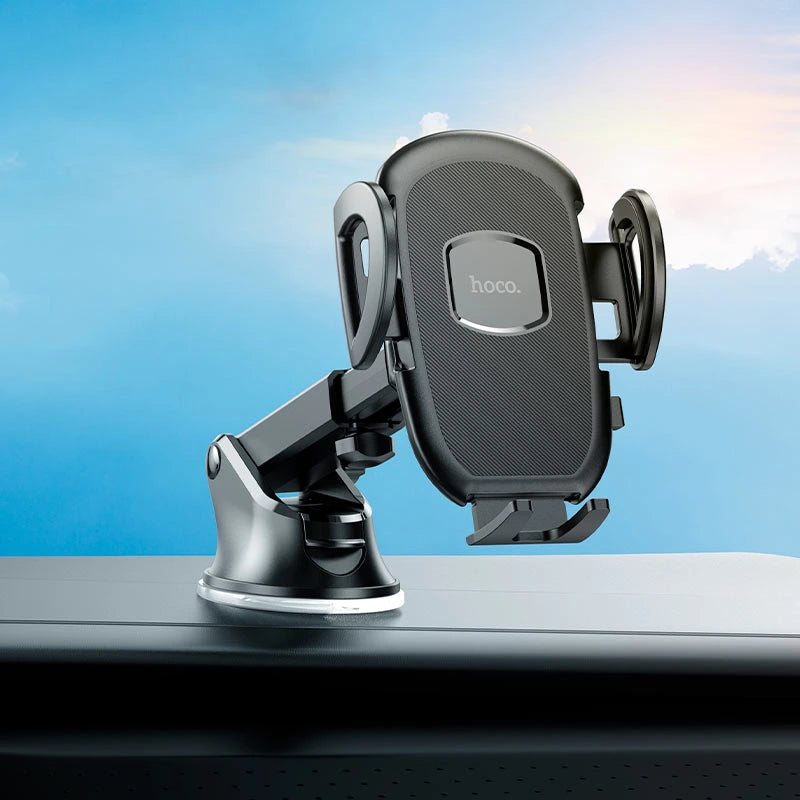 Car phone holder on a car dashboard with a blue sky background