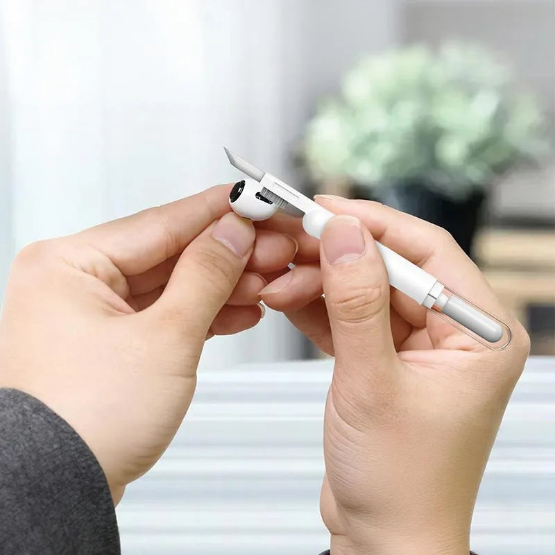 Hoco UT1 3-in-1 Digital Cleaning Pen lifestyle view showing hands using the high-density brush to clean an earbud at Lebtech Store Lebanon.
