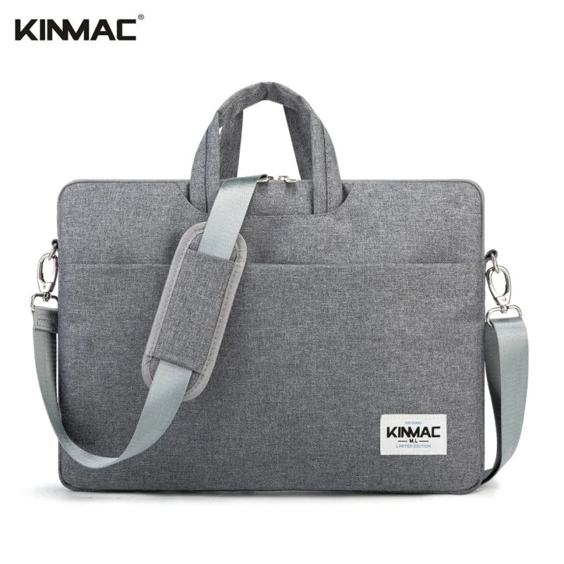 Gray laptop bag with shoulder strap and visible Kinmac branding on a white background