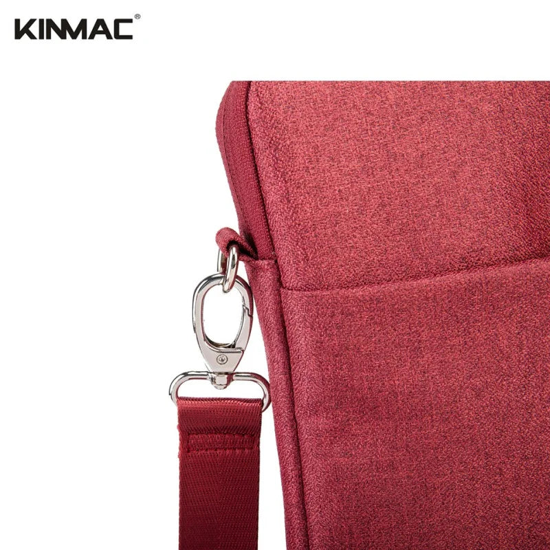 Red bag with a strap and clasp on a white background, featuring the KINMAC brand.
