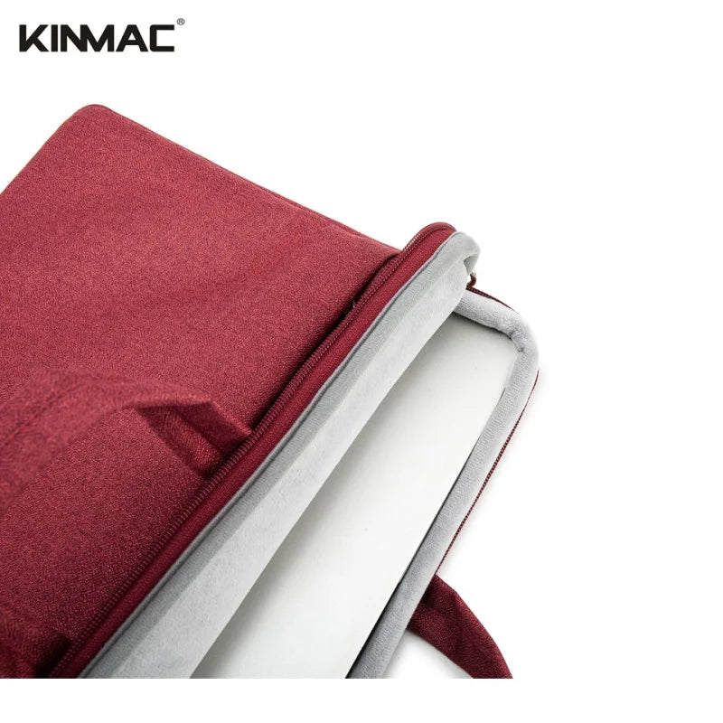 Red laptop sleeve with silver zipper on a white background, featuring the KINMAC brand.