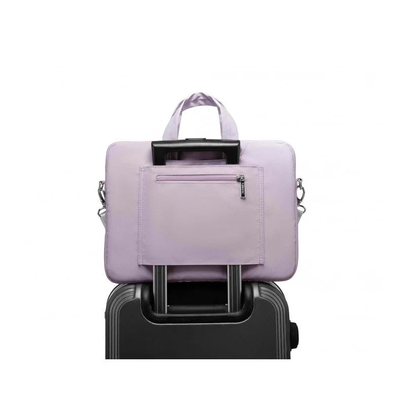 Purple backpack on top of a black suitcase on a white background