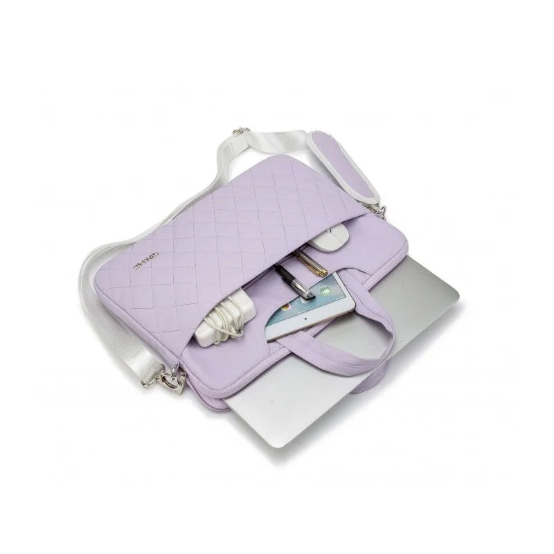 Lavender quilted handbag with a phone and bottle on a white background