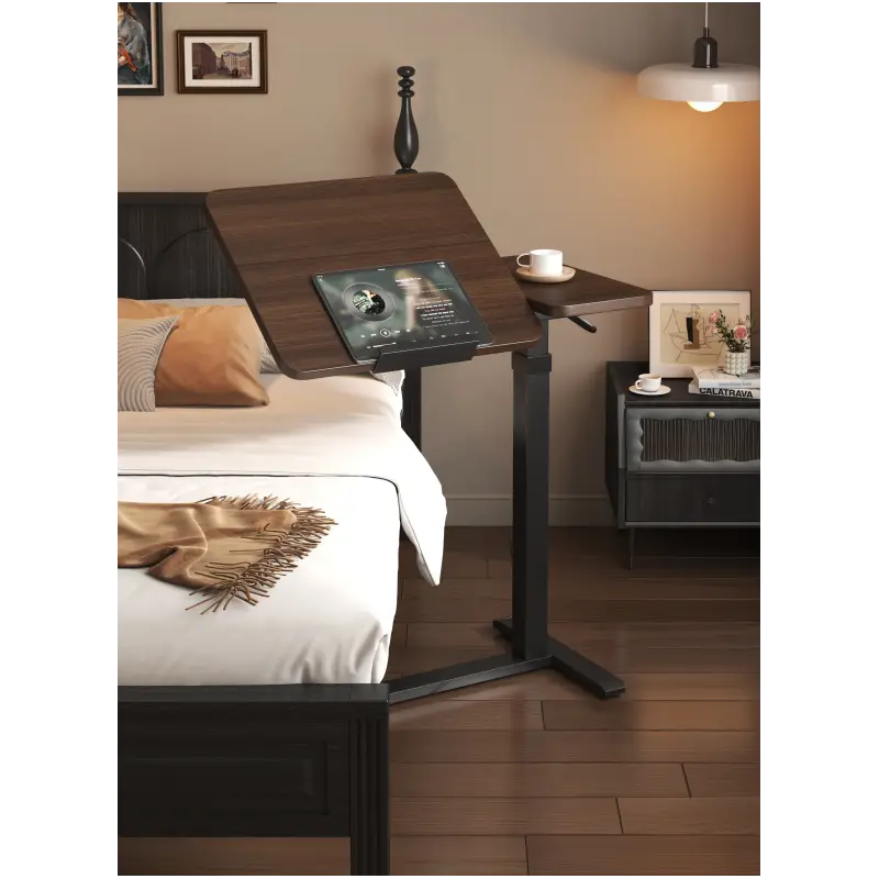 Dark wood height-adjustable bedside desk from LebTech Store Lebanon with a tilted surface for tablet use, showing the split-top design and sleek black frame for customers in Lebanon looking for a multi-function workstation