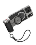 TELESIN Master Grip Bluetooth camera handle magnetically attached to the back of an iPhone case with a black leather texture, featuring a red shutter button and a wrist strap lanyard, available at Lebtech Store with fast delivery across Lebanon.