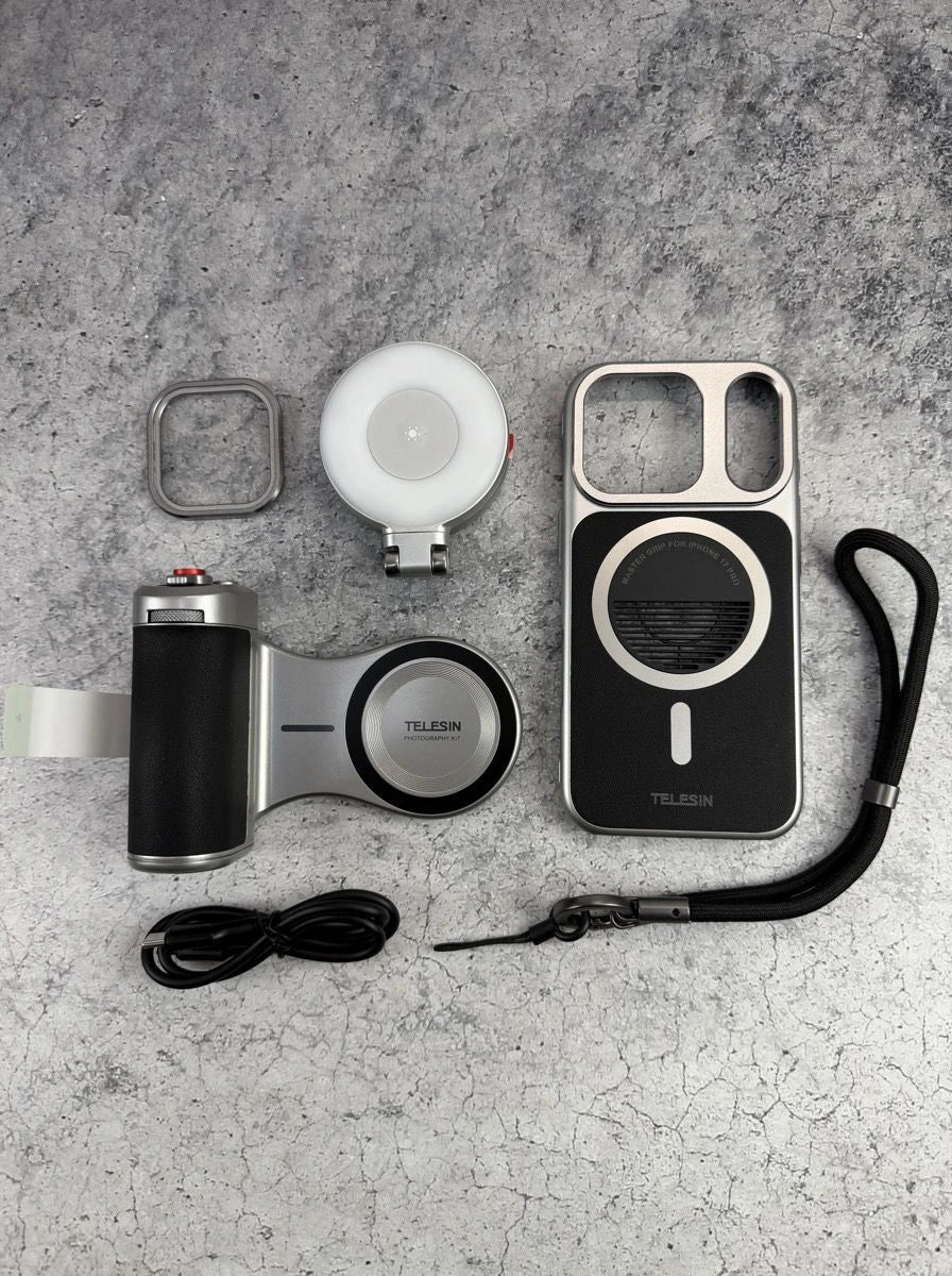  Flat lay view of the TELESIN Master Grip filmmaker creator kit including the black leather camera handle, MagSafe graphene cooling phone case, magnetic flip-up selfie fill light, lens filter ring adapter, and wrist lanyard from Lebtech Store Lebanon.