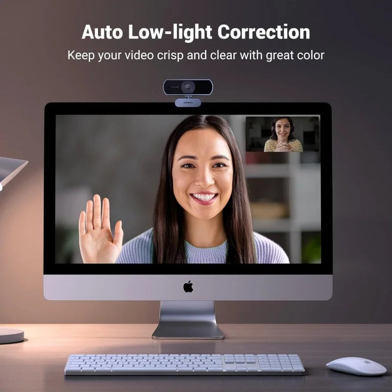 A person using the UGREEN HD 1080P webcam from LebTech Store Lebanon for a video call, showcasing the "Auto Low-light Correction" feature. The image demonstrates how the camera keeps video crisp, clear, and color-accurate even in dimly lit indoor environments.