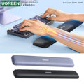 Product image for the Ugreen memory foam keyboard wrist rest available at LebTech Store, an official distributor in Lebanon. The top section shows the ergonomic support in use with an anatomical bone overlay, while the bottom displays the two available color options, grey and black