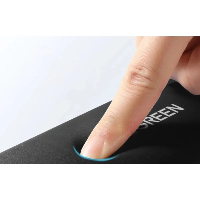 A close-up of a finger pressing into the soft memory foam of a Ugreen keyboard wrist rest from LebTech Store Lebanon, demonstrating its slow-rebound cushioning and responsive support