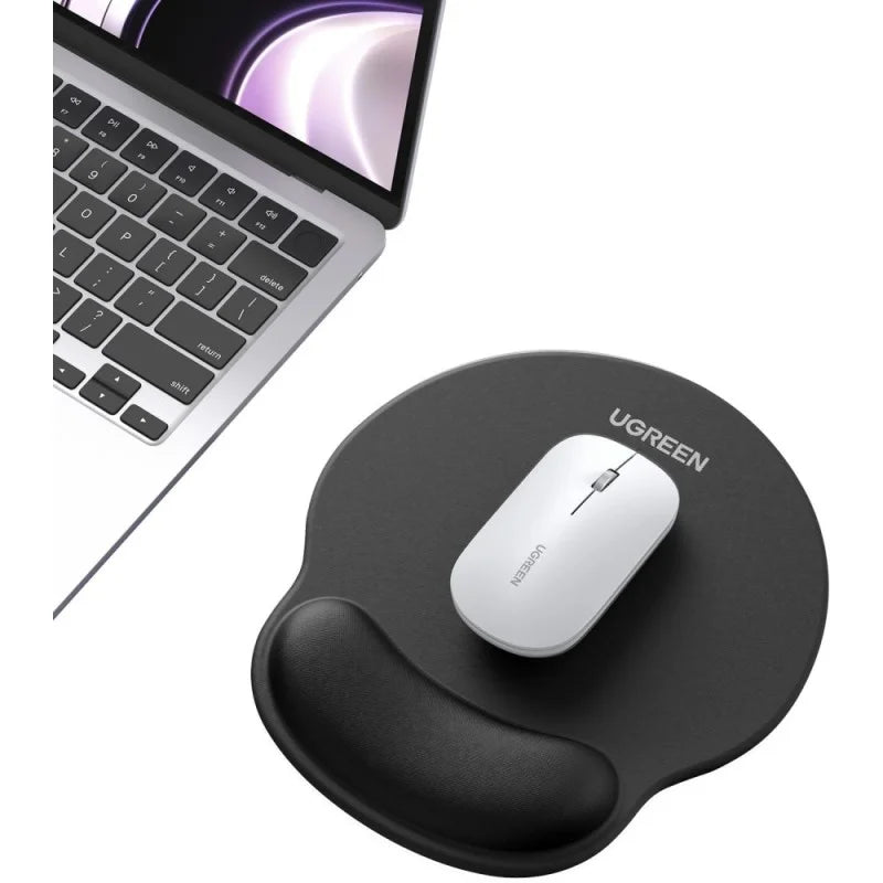A top-down view of a black UGREEN ergonomic mouse pad with a memory foam wrist rest, paired with a white wireless mouse and a laptop on a desk, available at LebTech Store Lebanon. This lifestyle image showcases the product's compact and professional look for any workspace.