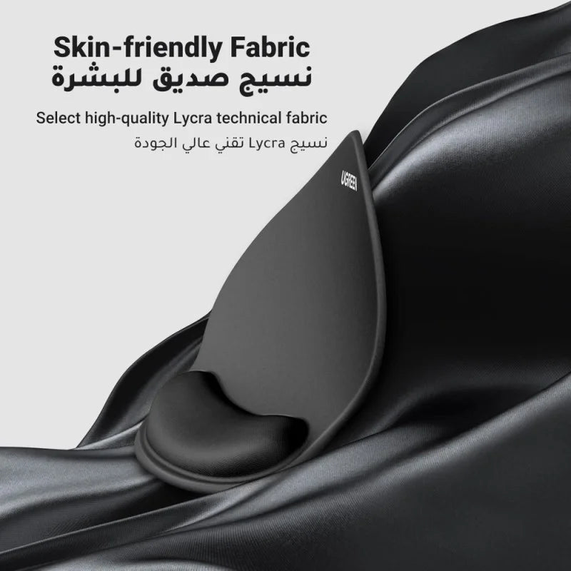 A black UGREEN ergonomic mouse pad from LebTech Store Lebanon shown against a draped black silk background. The image features English and Arabic text highlighting the high-quality, skin-friendly Lycra technical fabric used for a soft and smooth feel.
