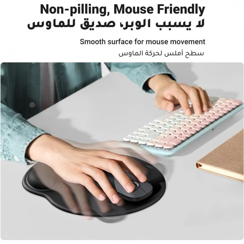 A person using a black UGREEN ergonomic mouse pad from LebTech Store Lebanon. The image features English and Arabic text highlighting its "Non-pilling, Mouse Friendly" smooth surface for effortless movement, while the built-in wrist rest provides comfortable support during use.
