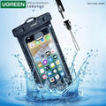 Main promotional graphic of the black Ugreen universal waterproof phone pouch splashing into water with its included lanyard strap, offered by official distributor channel at Lebtech Store Lebanon.